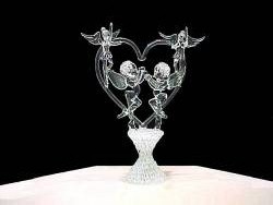 Angels wedding cake top with 2 solid glass Angel figurines, 2 solid glass Angel figurines on a solid glass heart all resting on a knitted glass base.