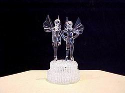 Fairy wedding cake top with a knitted glass base.