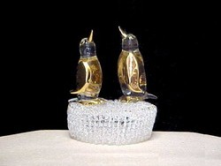 two solid glass Penguins on a knitted glass base