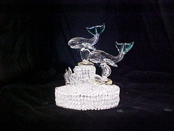two solid glass Wales wedding cake top on a two-tier knitted glass base with lots of sea life.